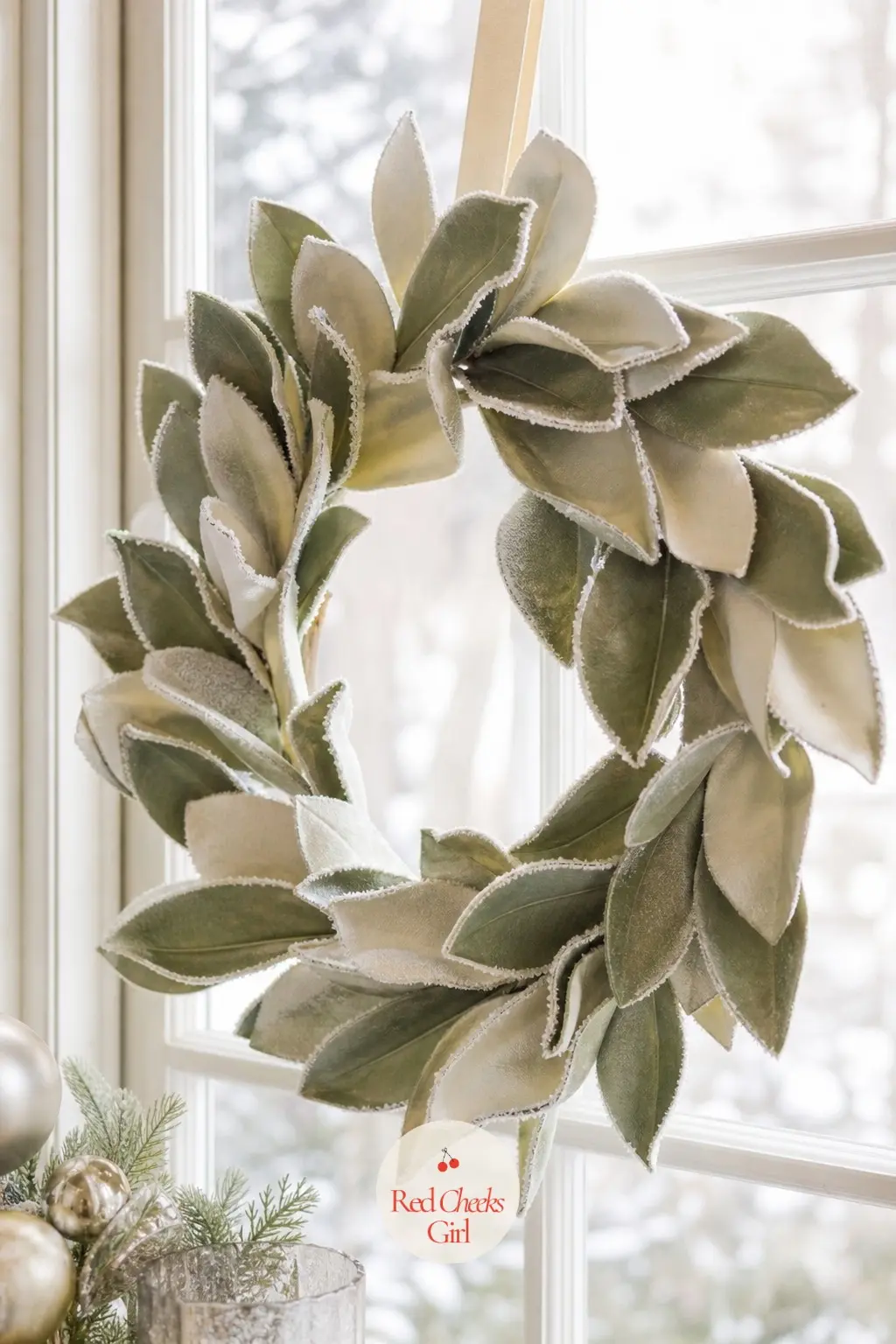 A Frosted Ivory Magnolia Wreath for the Sunroom Window — A light brushing of white chalk spray along each leaf edge gives a magnolia wreath a weathered