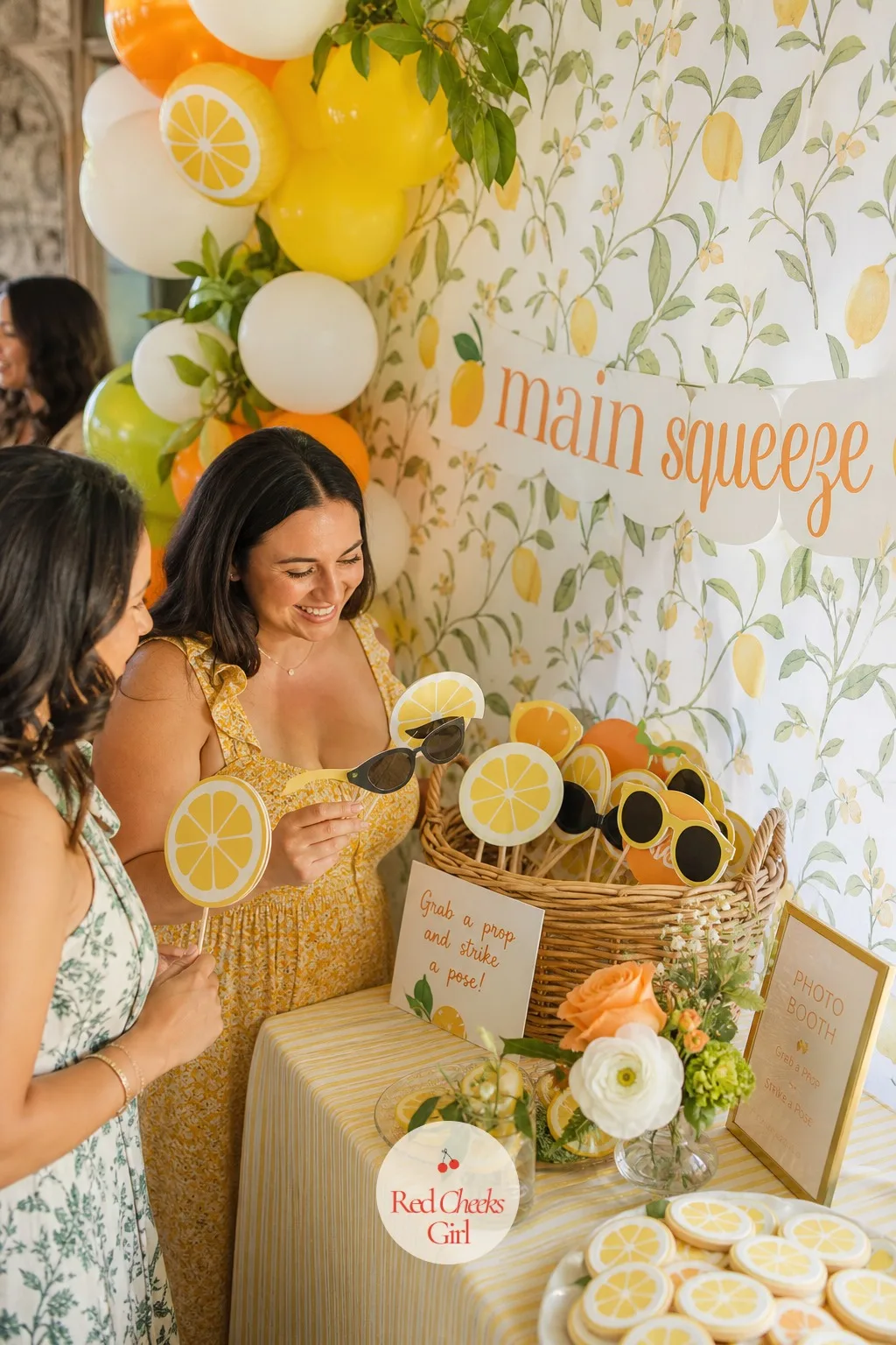 Citrus Photo Booth Props — A corner near the backdrop needs something for guests to actually do once the photo starts, beyond standing stiffly and smiling.