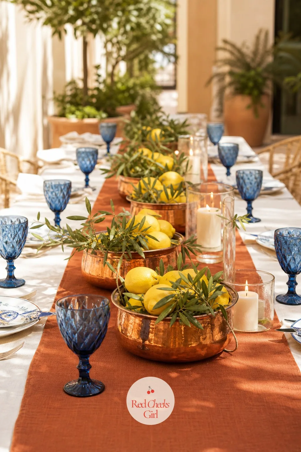 Citrus Centerpieces in Copper Pots — A tall floral centerpiece blocks the conversation across the table, which defeats the point of a long table in the first