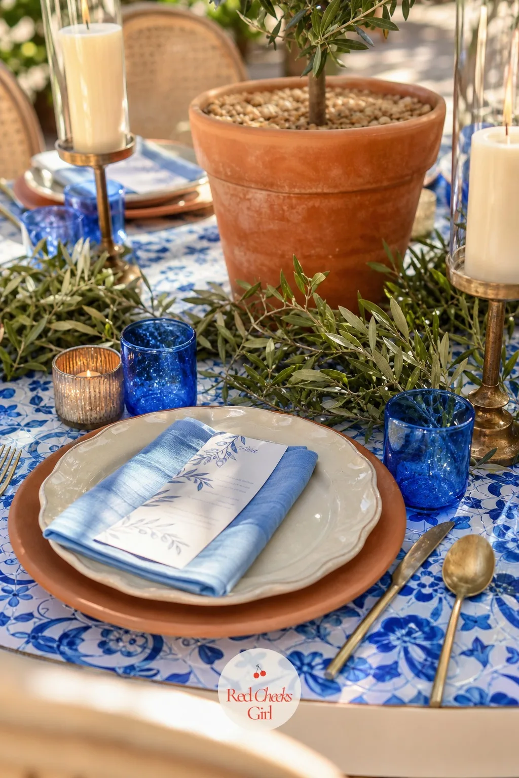 Terracotta and Blue Glass Tablescape — Plain white plates would read like any other wedding, and that is exactly the problem this solves. Mediterranean wedding