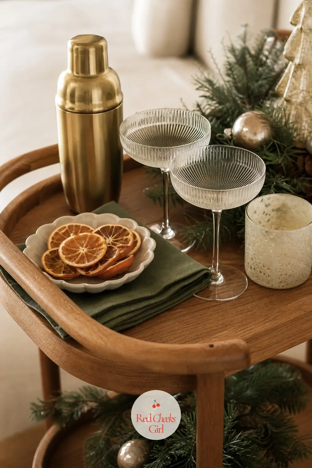 A Bar Cart Poured in Three Colours — Style the bar cart with only ivory glassware, one brass cocktail shaker, and a short dish of dried orange for garnish