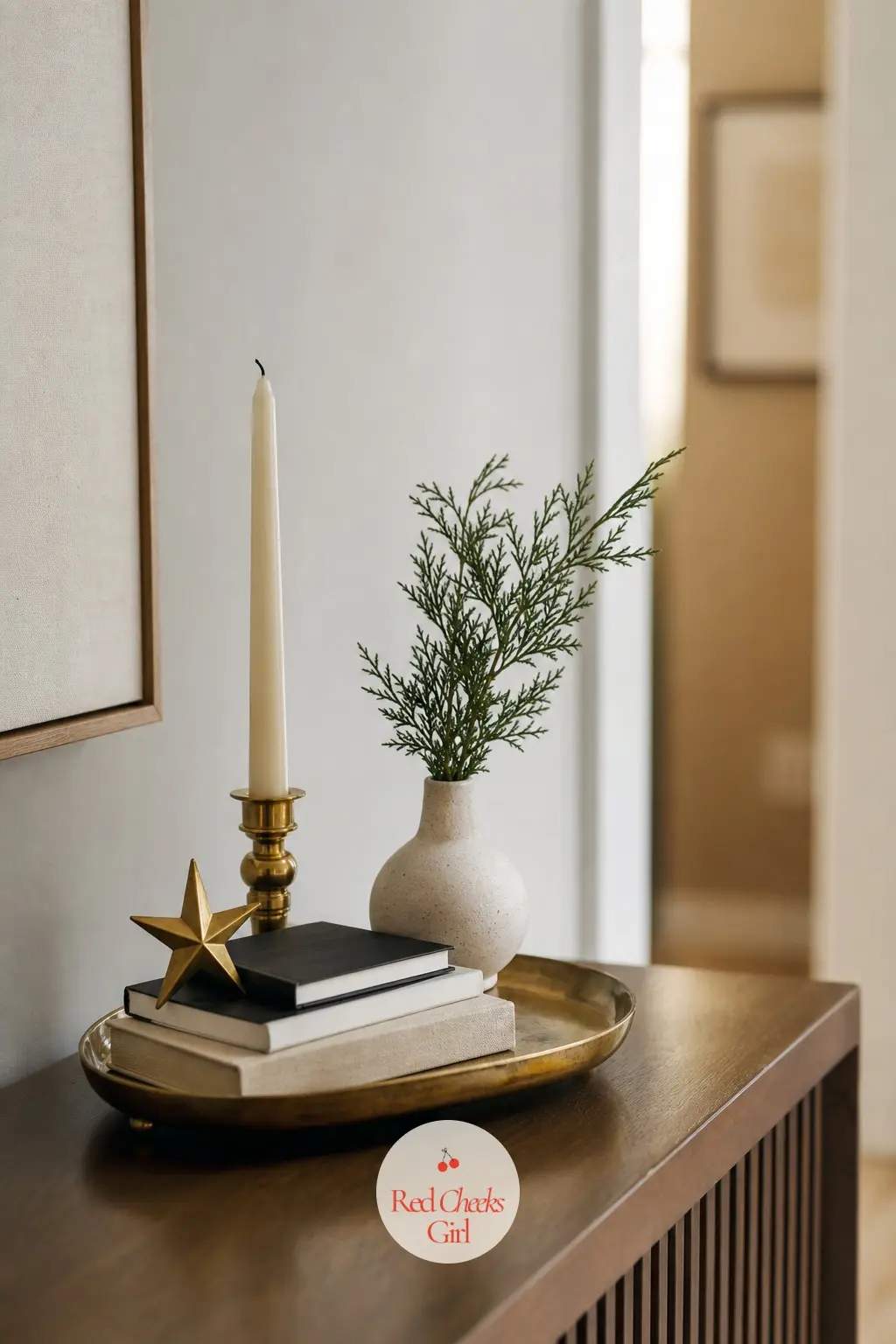 A Sideboard With One Tray, Styled Once — On the console or sideboard, group everything onto one brass tray rather than letting objects spread across the whole