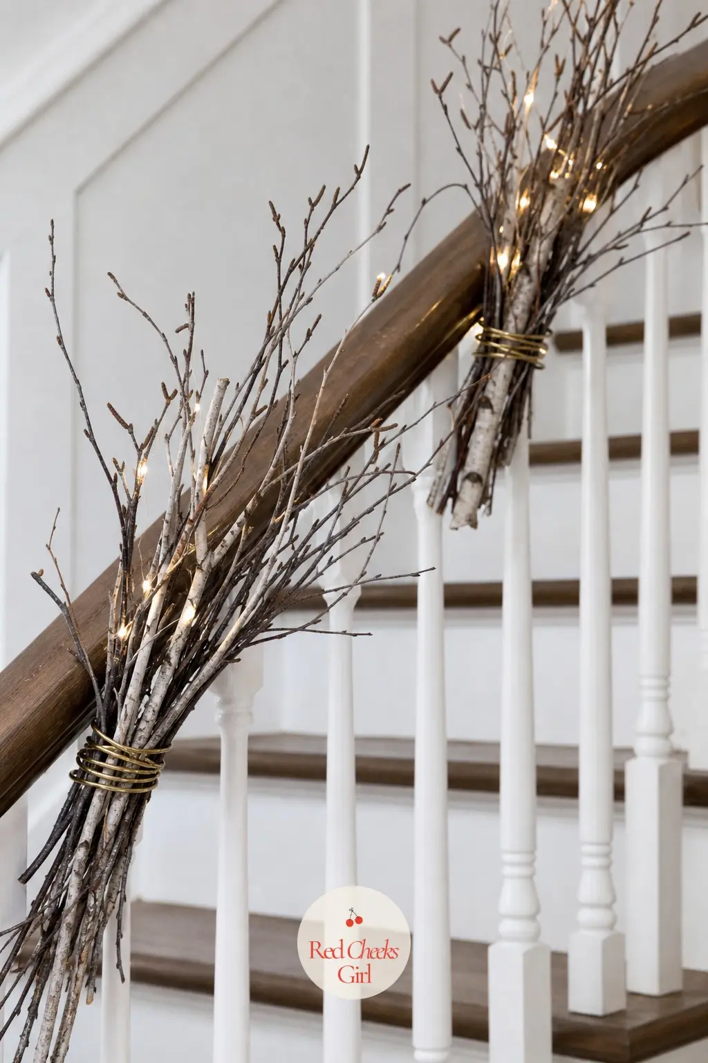 Bare Branches Threaded Through The Stair Rail — Rather than a garland, bind a handful of birch branch stems to the rail at intervals with slim brass wire