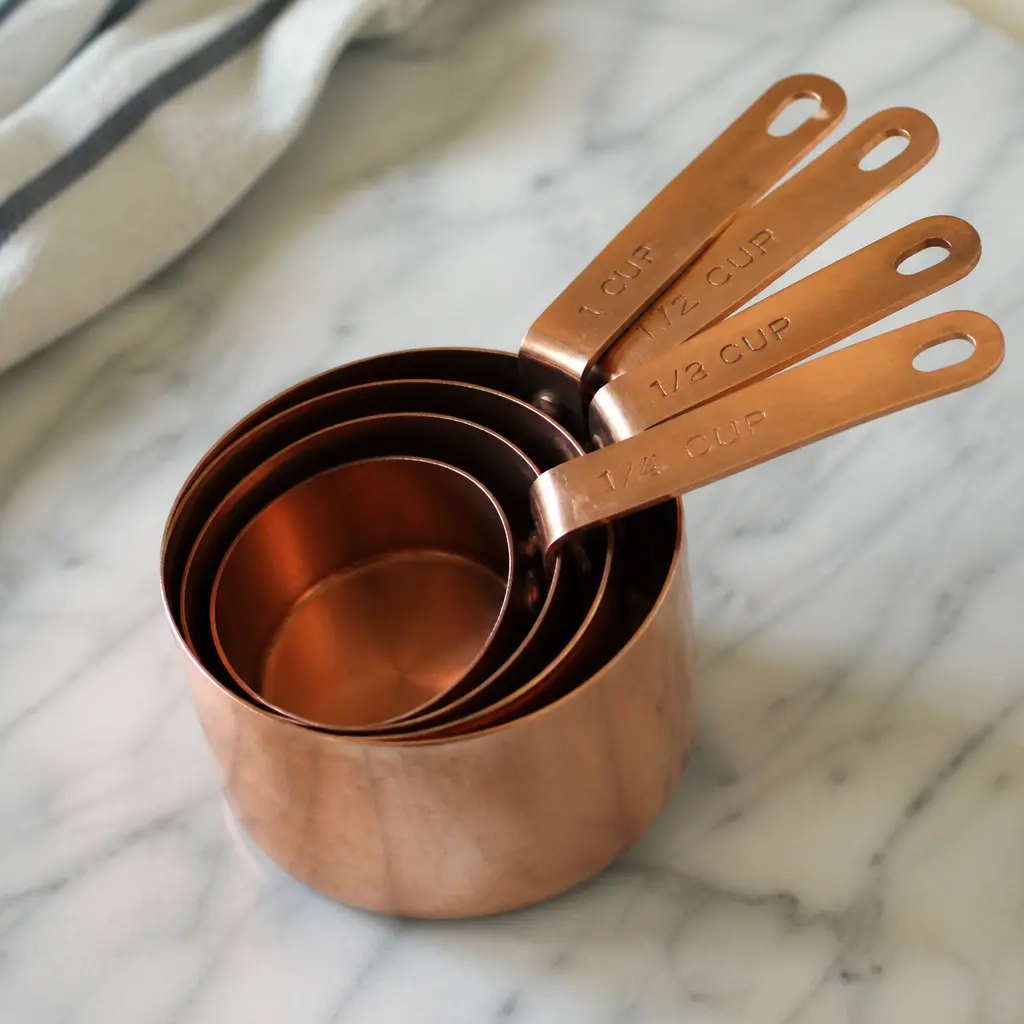 Copper Measuring Cups — A nesting set in warm copper, sturdy enough to survive decades of her signature cookies. Mother in law christmas gift ideas