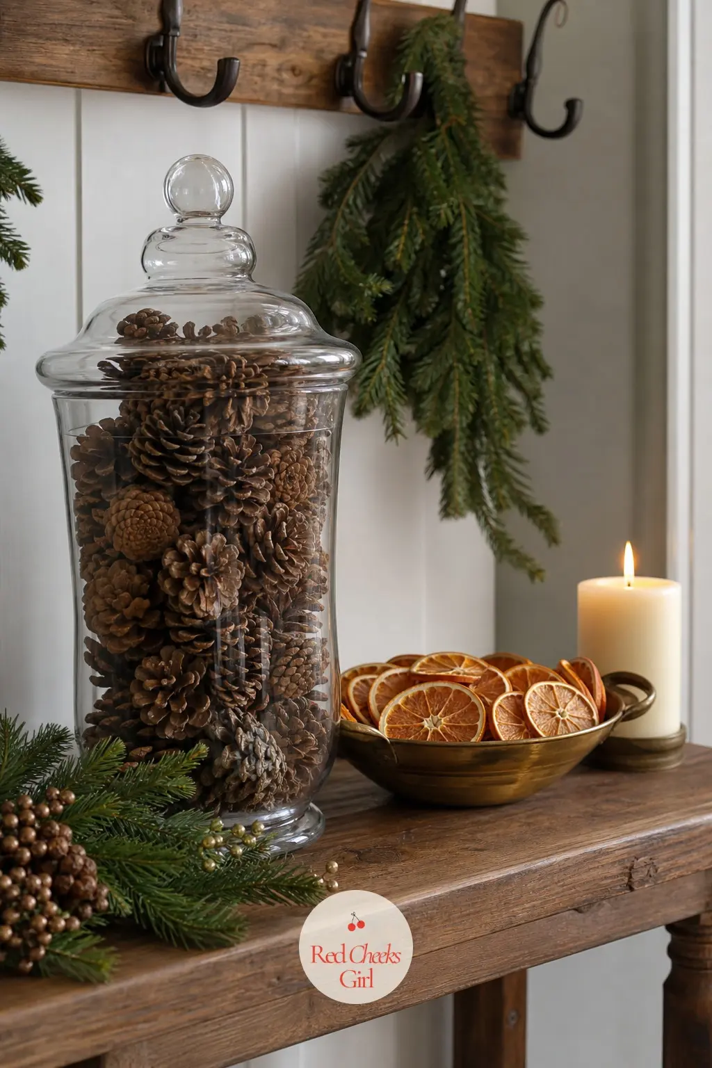 An Entry Table That Smells Like the Whole Idea — A tall glass apothecary jar filled with pinecones does more for an entryway than any framed sign ever could