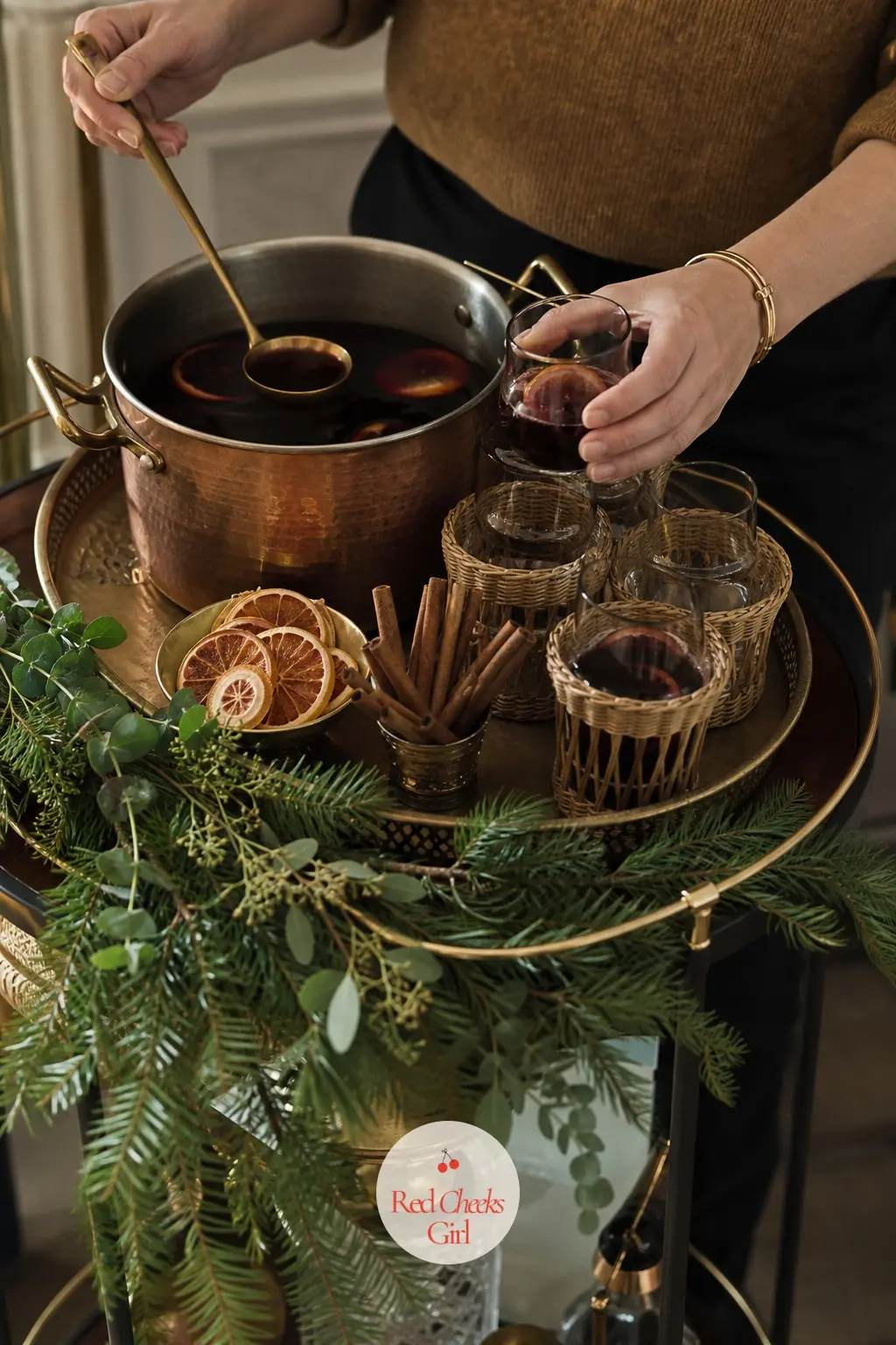 A Mulled Wine Station on the Bar Cart — A bar cart set up with a pot, a brass tray and a short stack of glasses turns into a proper drinks station once dried