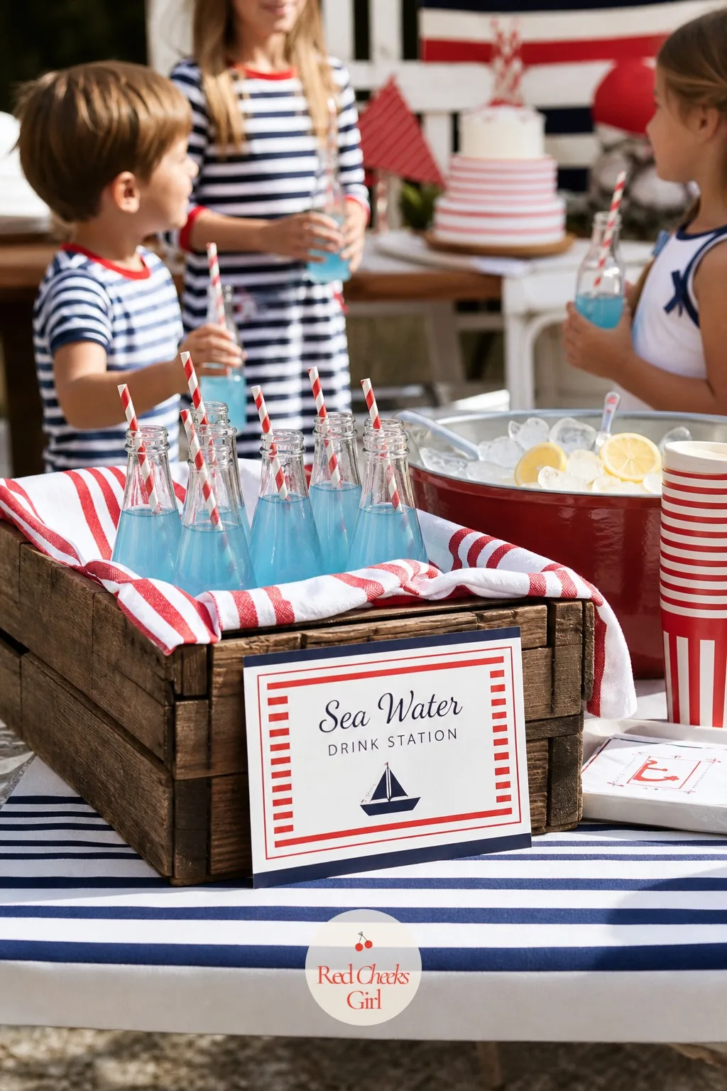 The Sea Water Drink Station — A drinks table with nothing but plain juice boxes does not photograph and does not feel like an occasion. Nautical birthday party