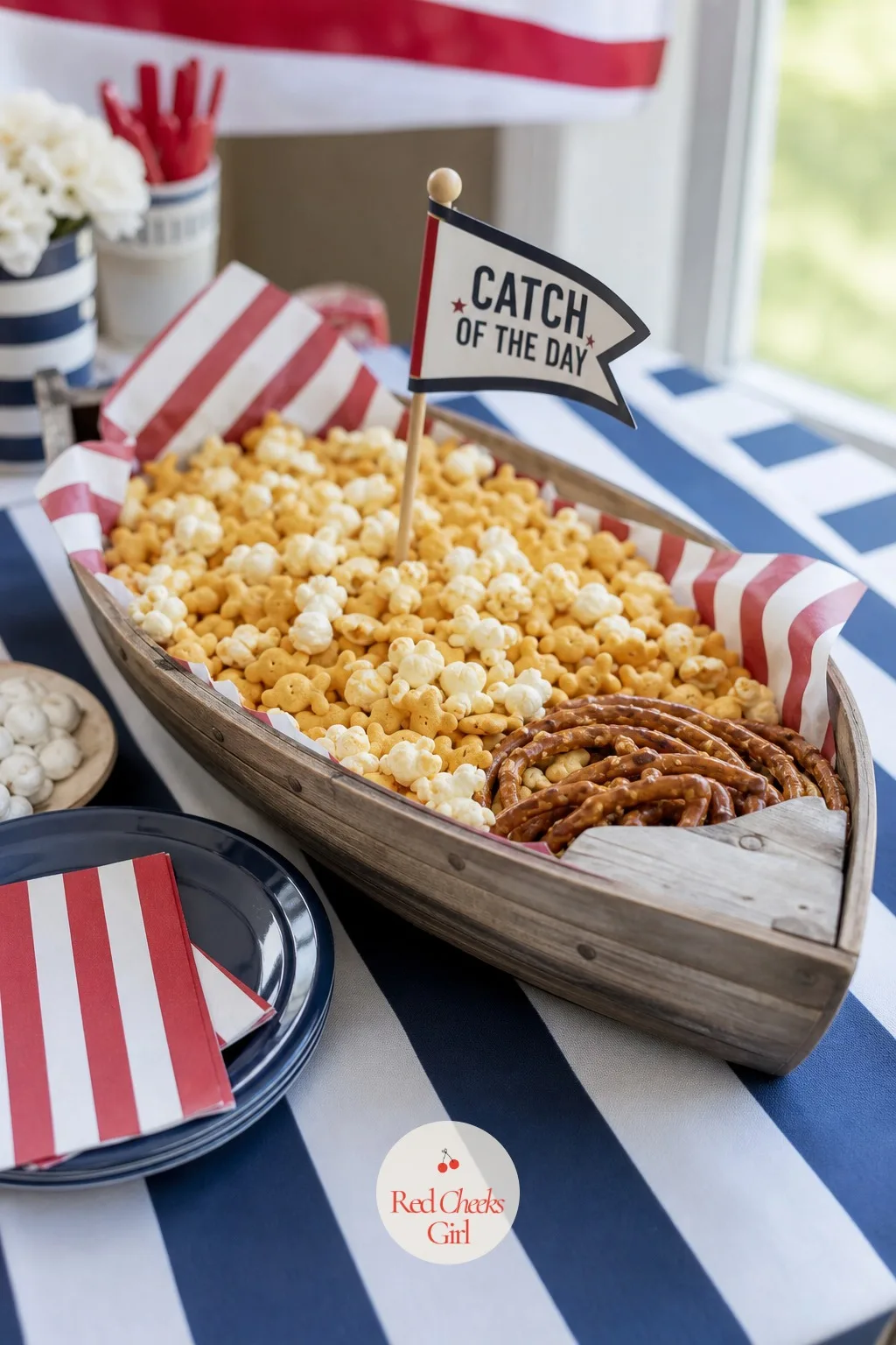 A Wooden Boat Tray of Catch of the Day Snacks — Savoury food needs its own moment, or it disappears under all the sugar and stripes. Nautical birthday party