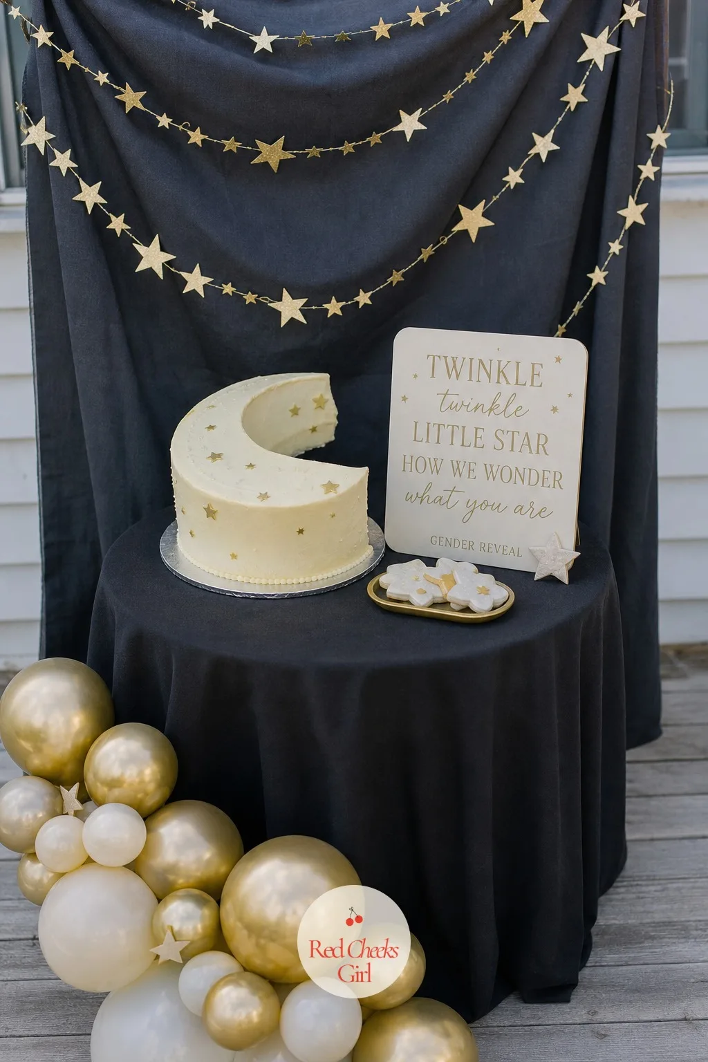 Celestial Corner — If the baby news feels like it deserves a little drama, this corner delivers it: a charcoal backdrop strung with gold star garland, set up