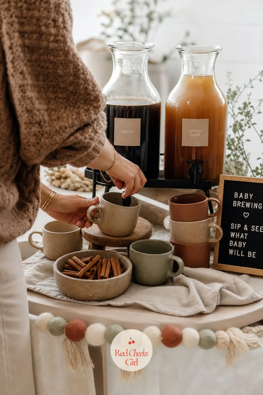 Hot Drink Station with Earth-Tone Mugs — For a cooler-weather reveal, a drink station does more work than another dessert ever could, giving people a reason to