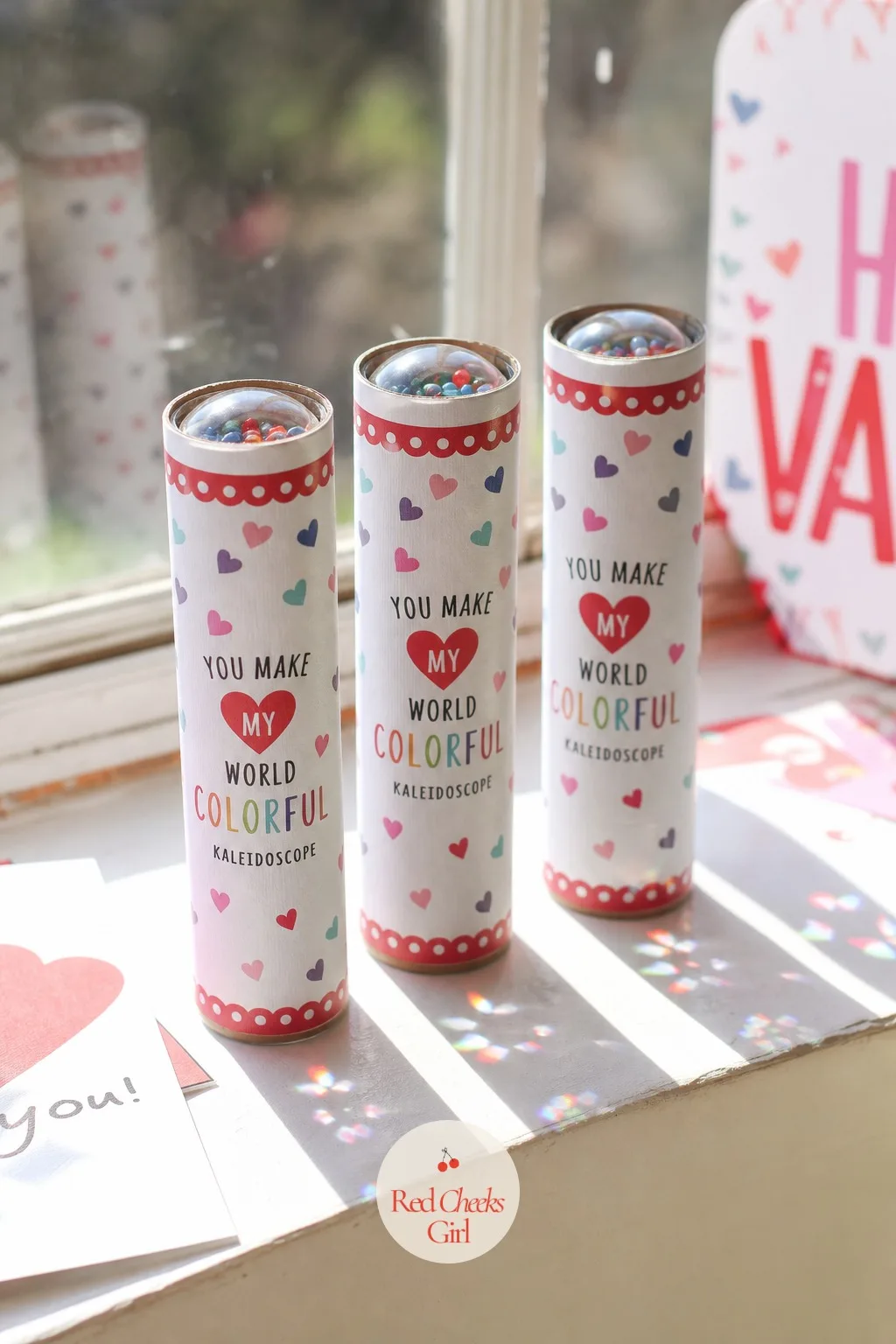 Mini Kaleidoscope: You Make My World Colorful — A cardboard tube kaleidoscope, mirrored foil inside and a handful of loose colored beads at one end, gives a