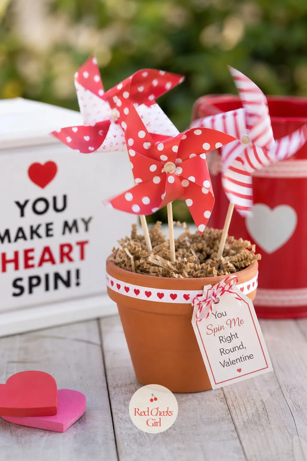 Mini Pinwheel: You Spin Me Right Round, Valentine — A paper pinwheel pinned to a thin wooden dowel spins on its own in a drafty hallway, which makes it the