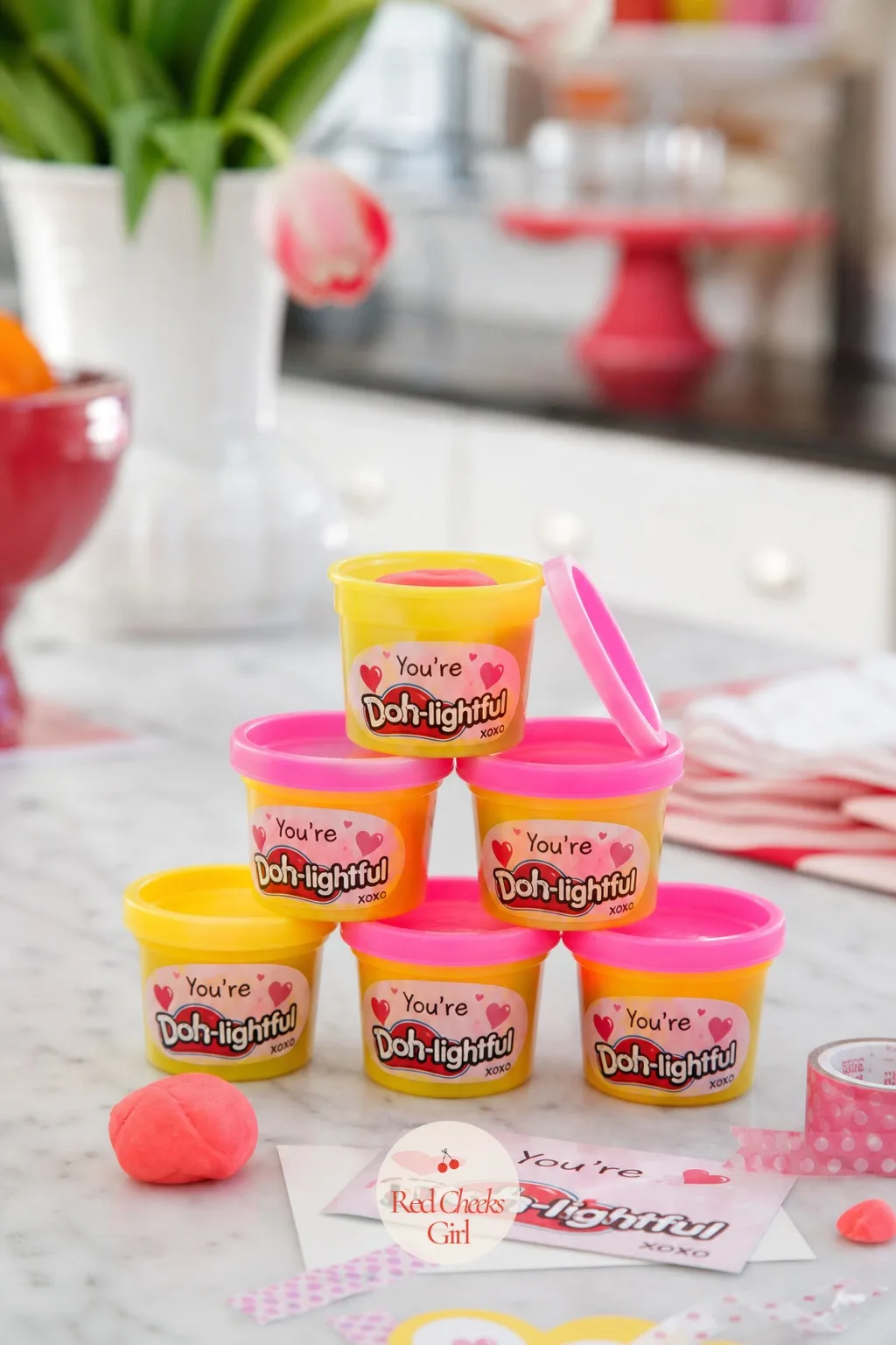 Mini Play-Doh Tubs: You're Doh-lightful — Small tubs stacked into a short pyramid, one lid popped to show the dough underneath, photograph better than a single