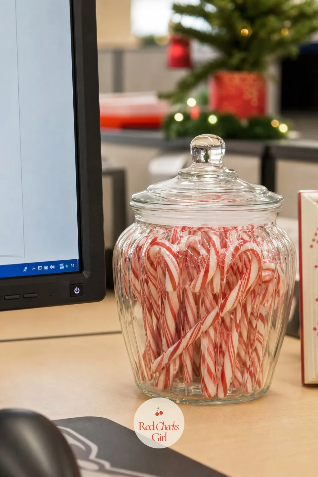 Candy Jar by the Monitor — A desk with a candy jar on it gets visitors, and in a cubicle that is half the point of decorating at all. Office christmas