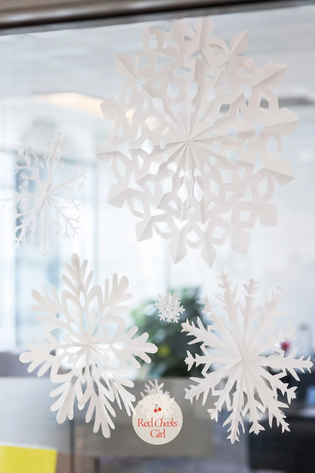 Cut Paper Snowflakes on the Glass — If scissors and a stack of white paper are the only craft supplies within reach, this is the entry that uses them. Office
