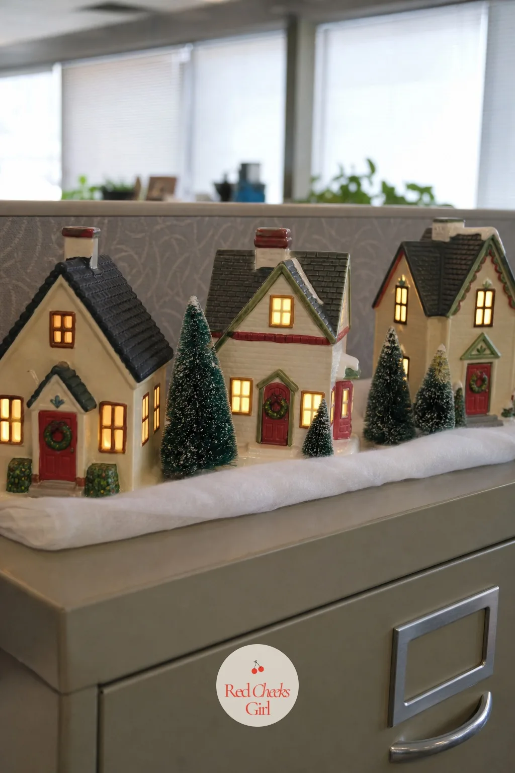 Mini Village on the File Cabinet — The top of a file cabinet or low shelf is usually dead space, and a row of miniature lit houses turns it into the one corner