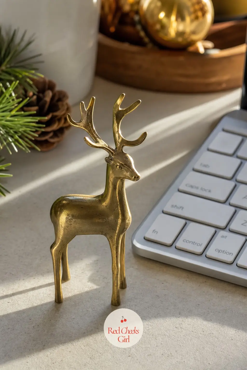 A Small Brass Reindeer Paperweight Set Beside the Keyboard — One small brass reindeer figurine does the whole job of a desk decoration without taking up room a