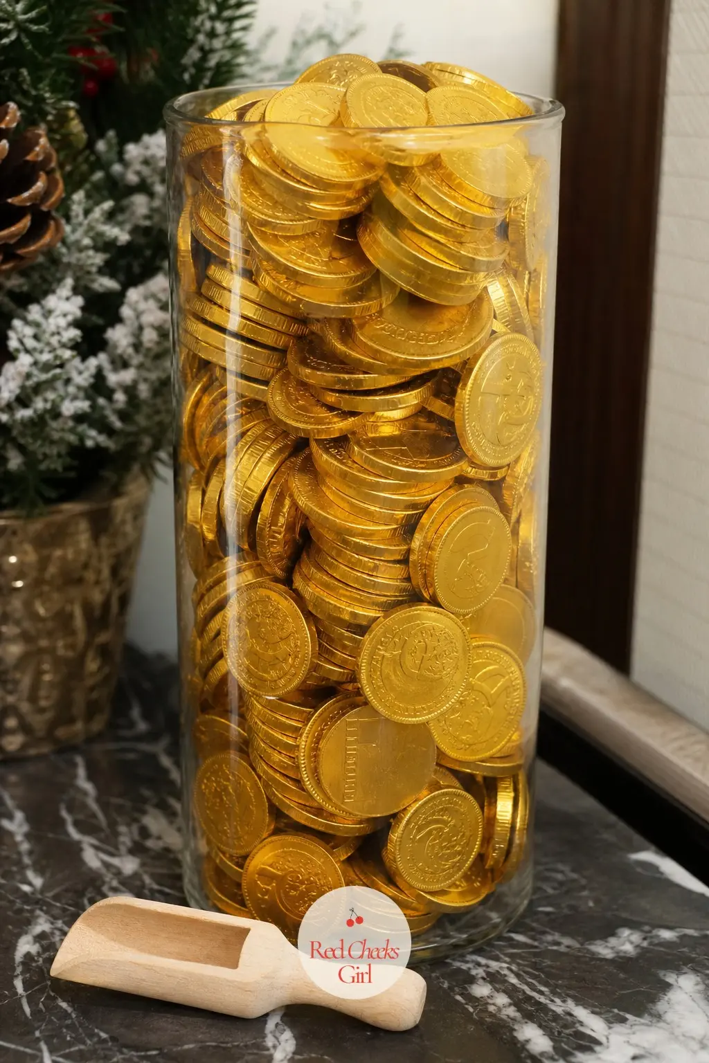 A Stack of Wrapped Chocolate Coins Left in a Glass Jar at Reception — A tall glass jar of gold wrapped chocolate coins at the reception counter does double