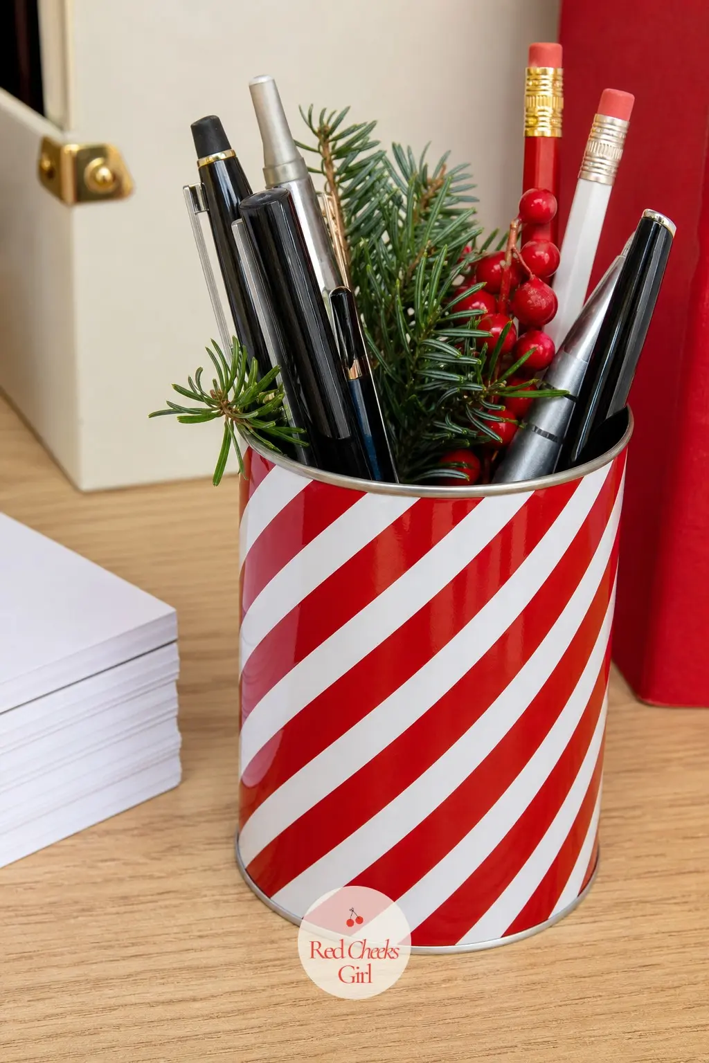 A Striped Tin Swapped In for the Everyday Pencil Cup — The pencil cup already sits on every desk, so replacing it for one season costs nothing in extra space.