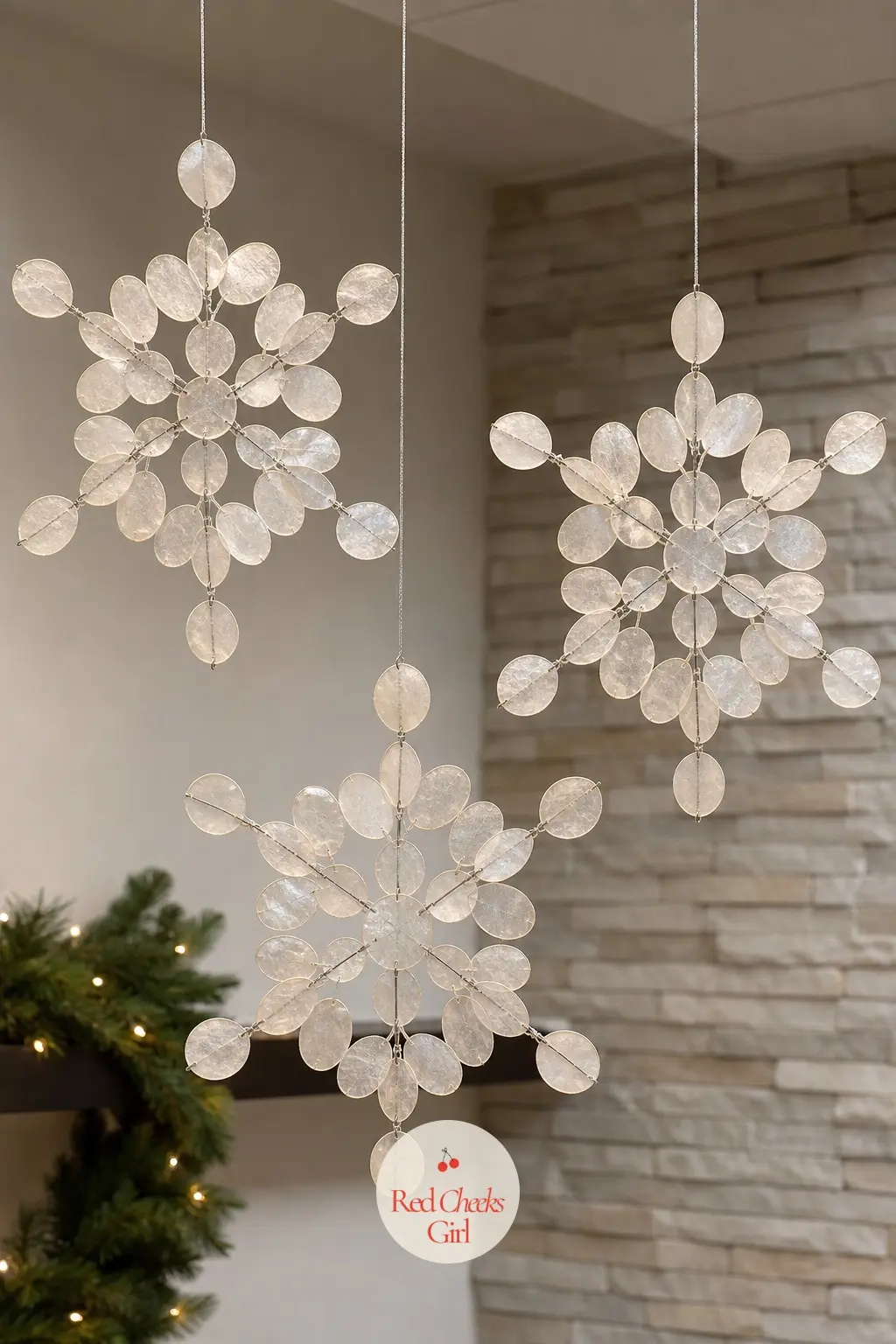 A Trio of Capiz Shell Snowflakes Hung Over the Waiting Area — Capiz shell snowflakes catch light in a way paper or plastic never quite manages, and three hung