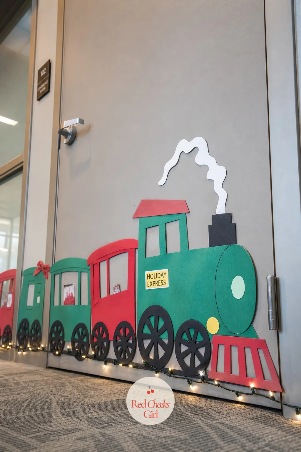 Christmas Train — A train running the length of a door gives the whole floor something to follow car by car, which matters when three other doors are also