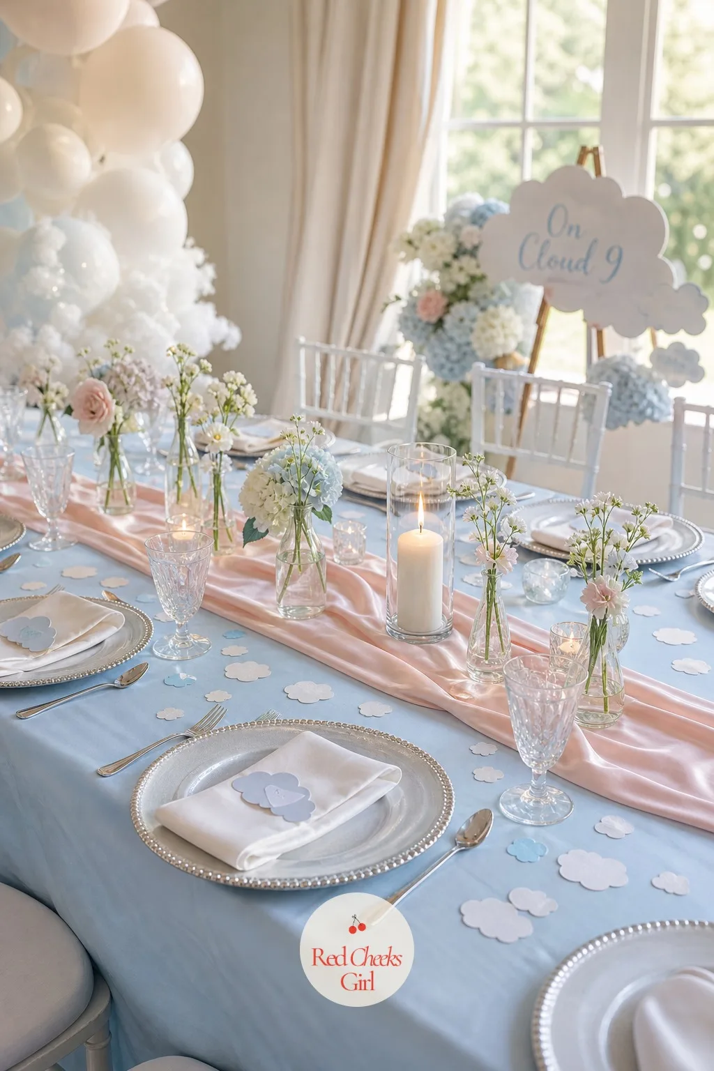 Pastel Tablescape — She sits down and the ceiling's sky comes down to table height: a pale blue tablecloth, a blush satin runner laid straight down the center