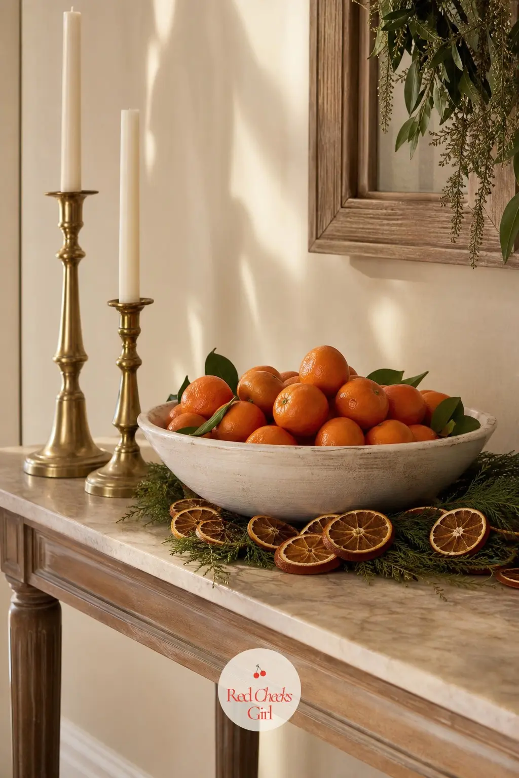 The Console Table, Styled with a Bowl of Clementines and Brass Candlesticks — A wide bowl of fresh clementines, skins left on, sits at the centre of the