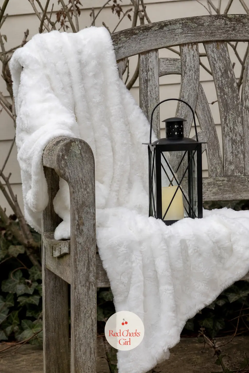 A Garden Bench Dressed with a Faux Snow Throw and a Single Lantern — A plain garden bench gets one faux snow throw draped over the back and a single black