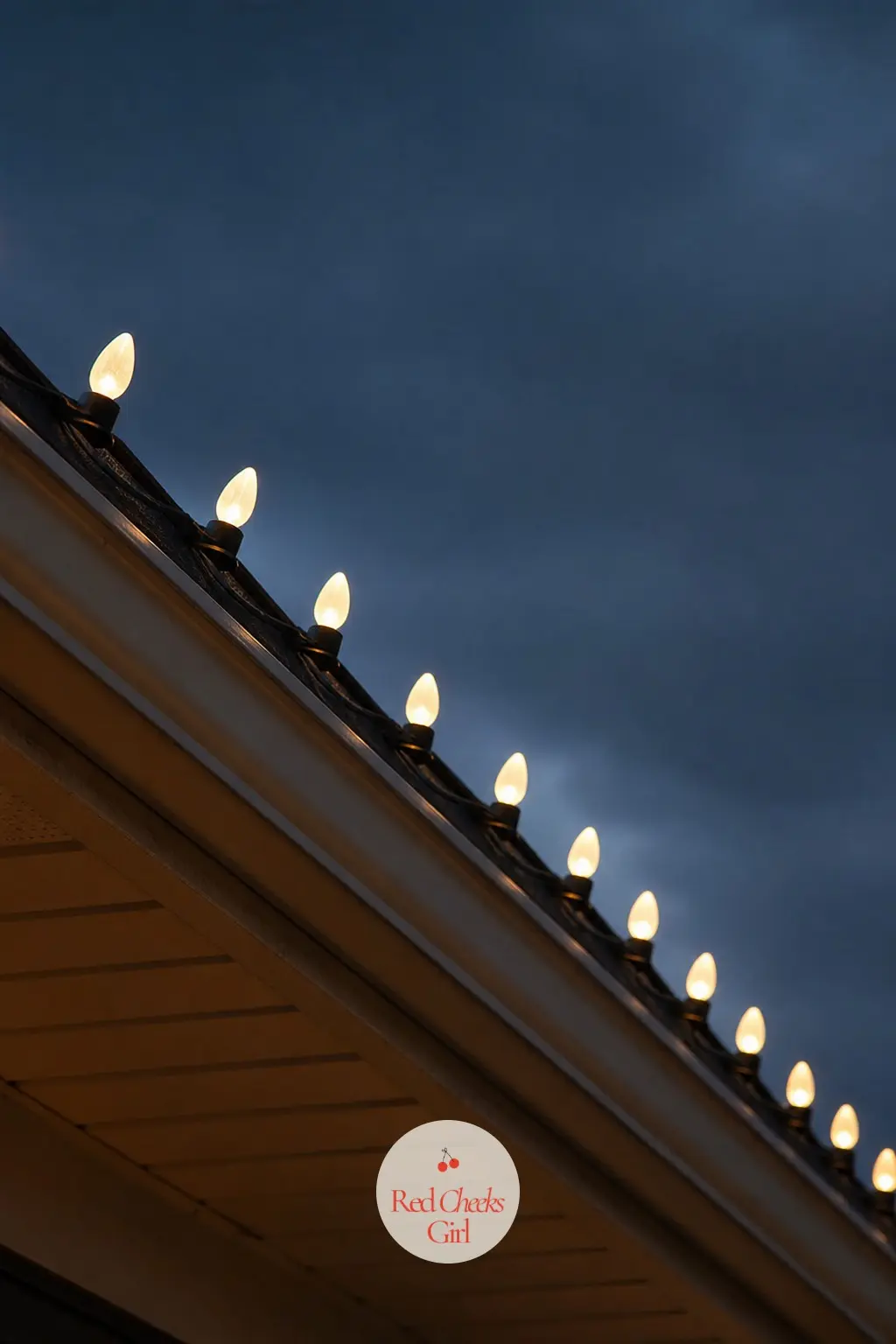The Roofline Traced in Warm White C9 Bulbs — Classic large C9 bulbs, clipped evenly along the roof edge in one single colour, read cleaner from a distance than