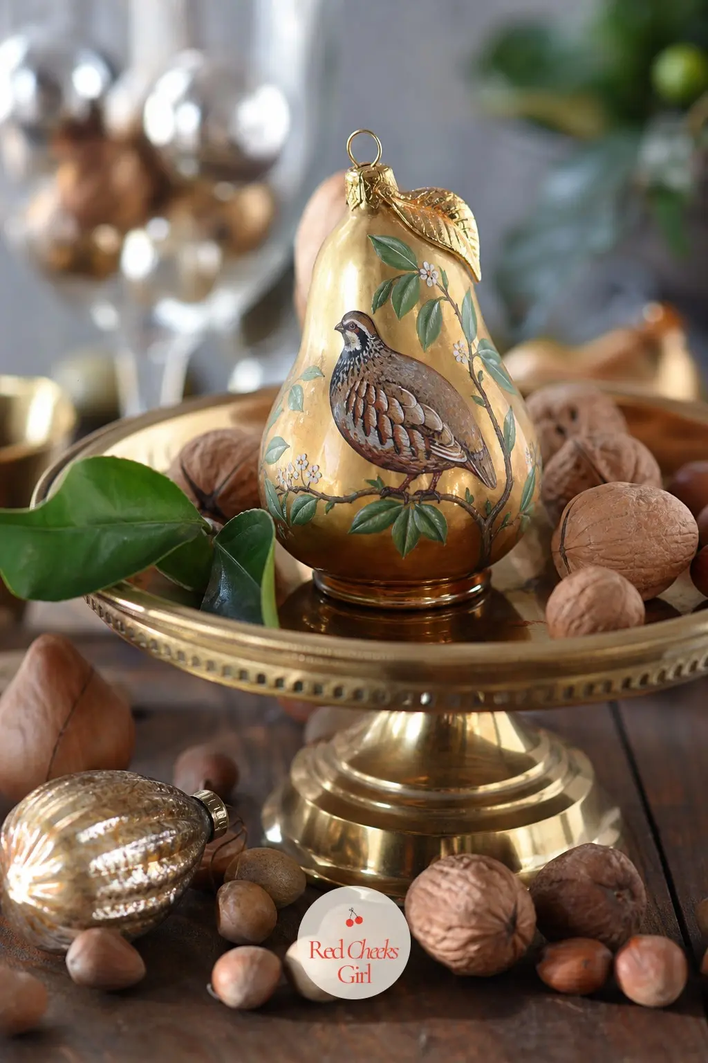 Partridge in a Painted Pear — The Partridge in a Painted Pear turns the old carol into an actual object: a bronze bird painted onto a golden ceramic pear, one