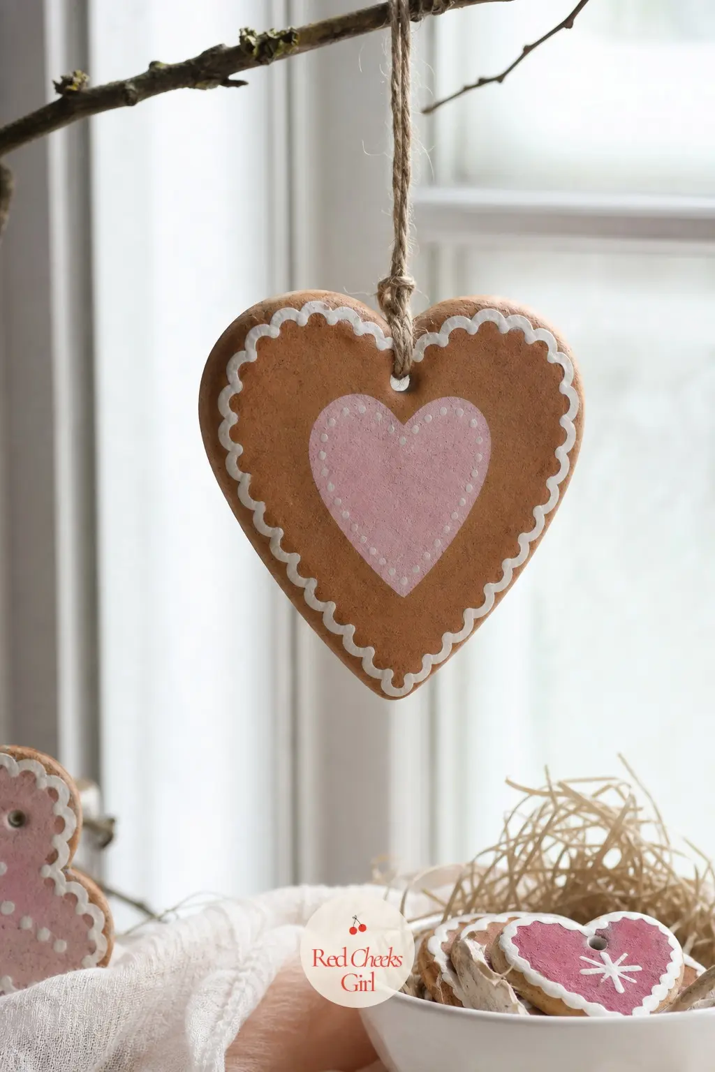 Iced Gingerbread Heart — Less jolly, more tender: a heart-shaped cutter instead of a figure, painted in the same warm brown but finished with a scalloped white