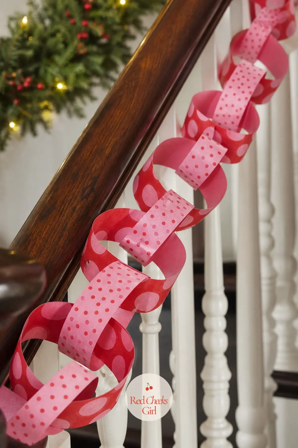 Red and Pink Polka Dots Paper Chain — Red and pink dots in varying sizes across the strips, some strips a red ground with pink dots, others flipped, so the