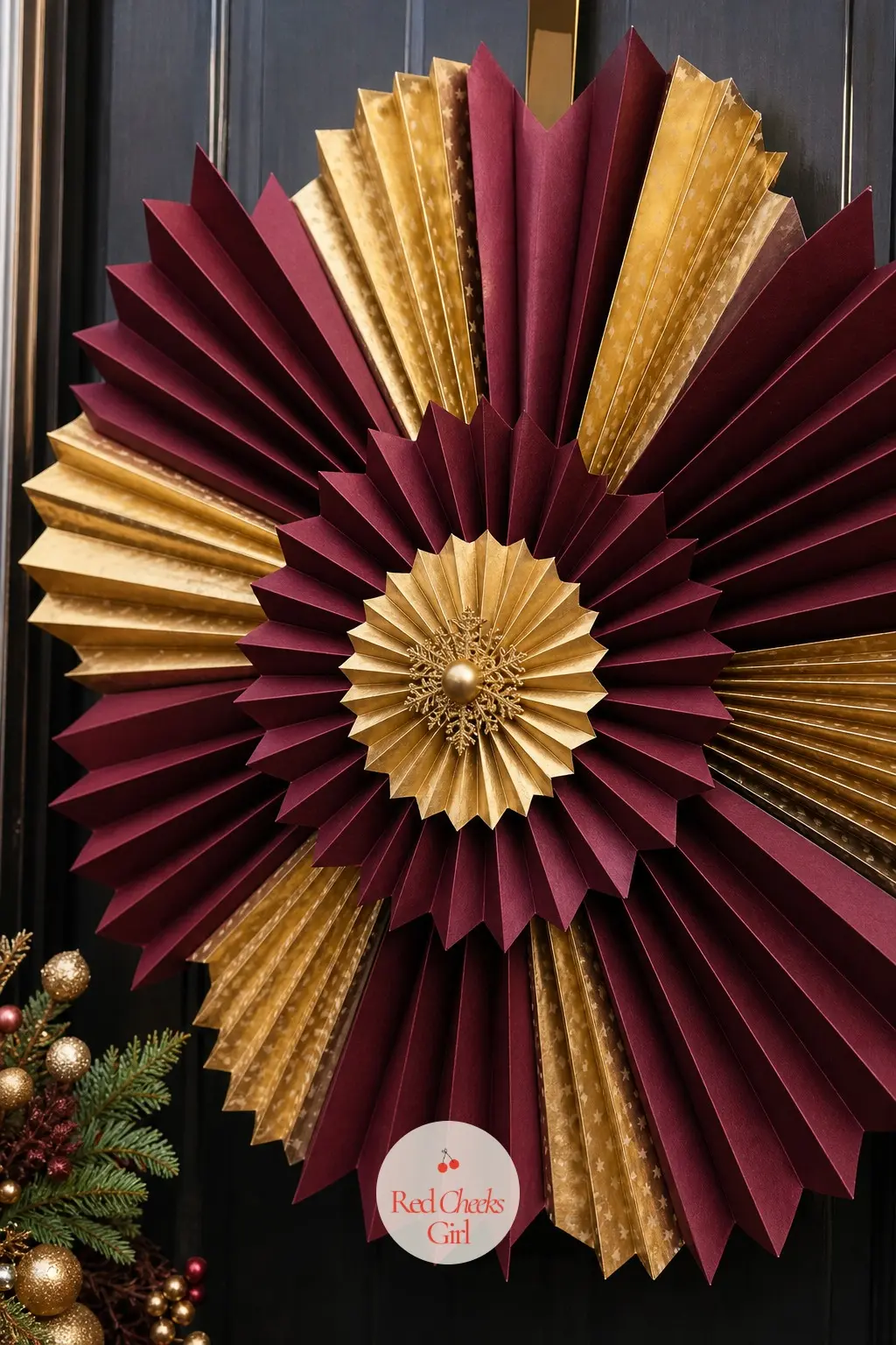 The Burgundy and Gold Paper Fan Sunburst Wreath for the Home Theater Door — Pleated burgundy and gold paper fans radiate from a central point rather than