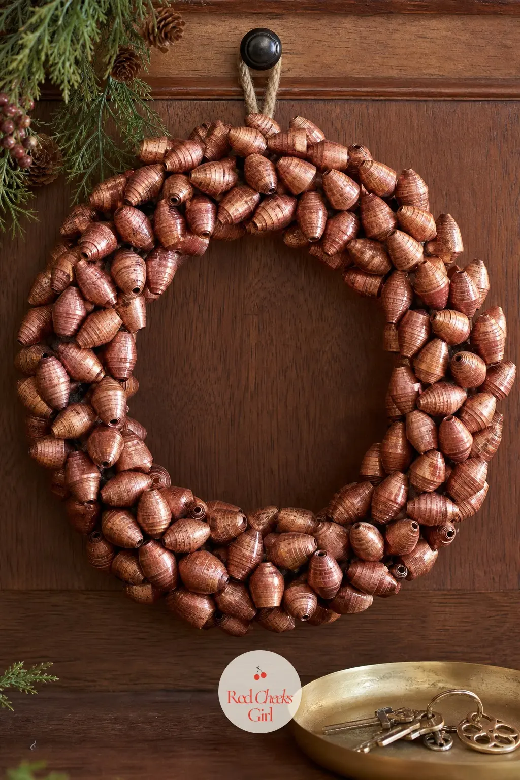The Copper and Rust Rolled Paper Bead Wreath for the Entry Console — Long triangles of copper and rust paper roll around a skewer into bead shapes, then string