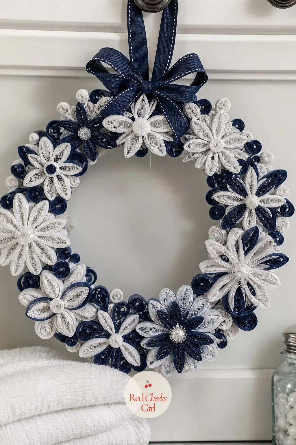 The Navy and White Quilled Snowflake Medallion Wreath for the Laundry Room — Navy and white quilling strips coil into small snowflake-shaped medallions rather