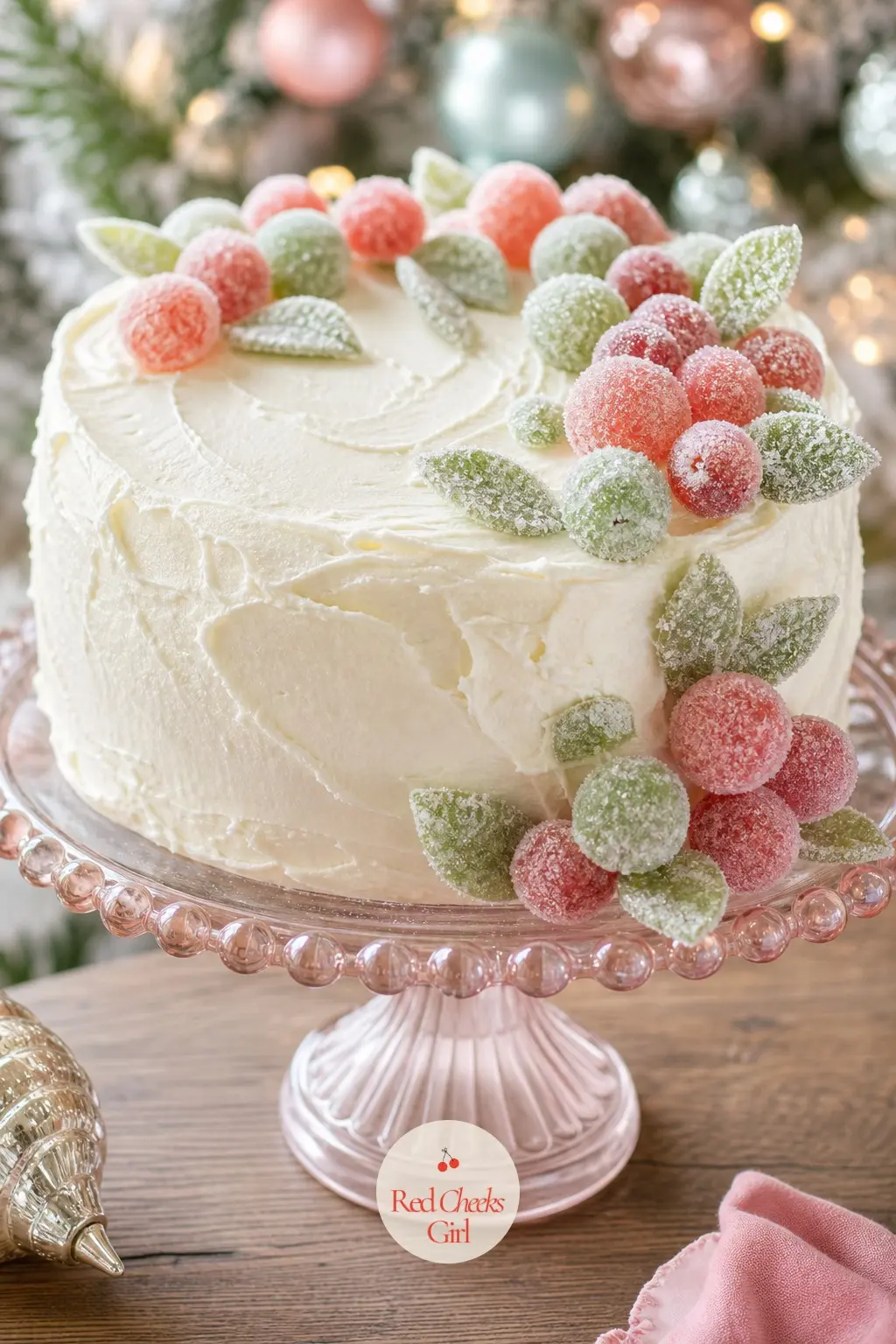 The Cake Stand, Piled with Sugared Fruit and Buttercream Frosting — A pastel glass cake stand holds a buttercream-frosted cake ringed with sugared fruit in