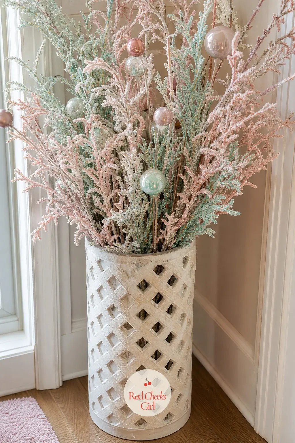 The Umbrella Stand, Filled with Frosted Pastel Branches — An old umbrella stand gets repurposed for the season, filled instead with frosted glitter branches in