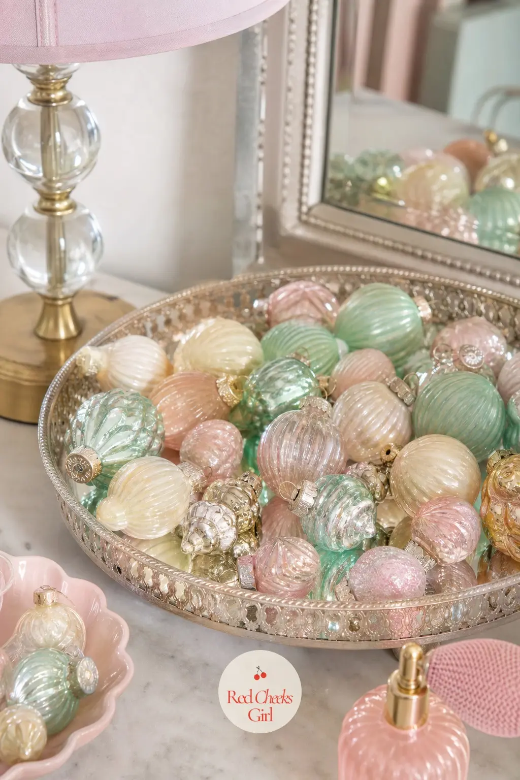 The Vanity Tray, Set with Mini Glass Baubles — A mirrored tray on the bedroom vanity holds a small pile of mini glass baubles in the three core colours