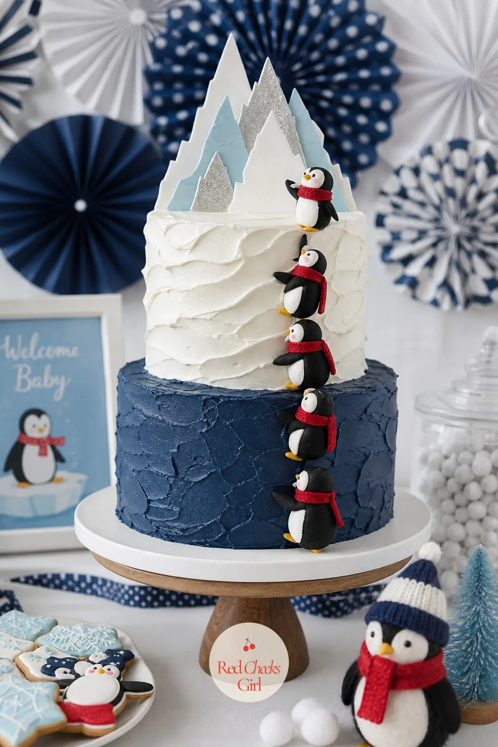 Navy and White Iceberg Tier Cake — The cake carries the one photograph everyone keeps from the whole afternoon, so it is worth the extra attention. Penguin