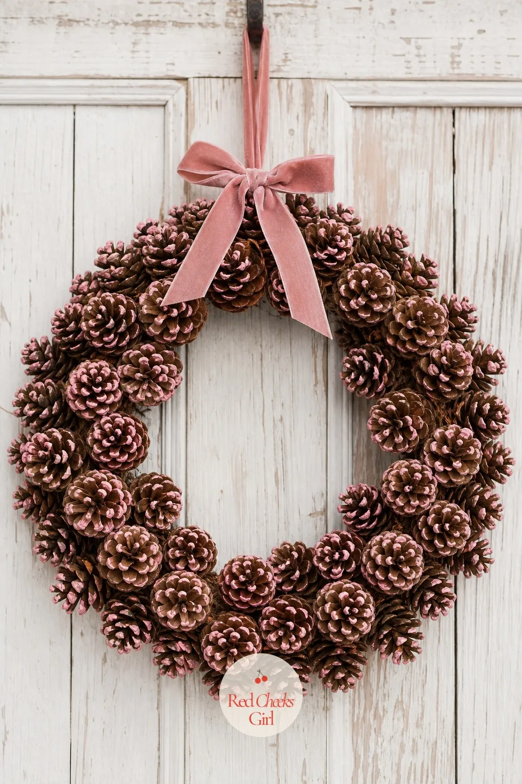 Blush-Tipped Painted Pinecone Wreath — A wreath that is only green and red can start to look like every other door on the street by the second week of