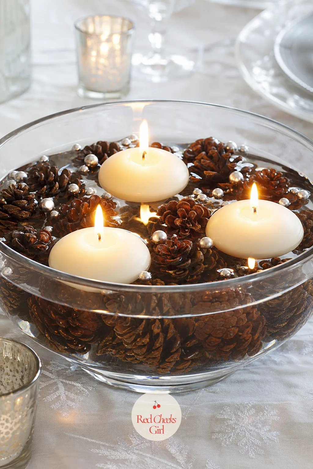 Floating Candle And Pinecone Centerpiece — A tall centerpiece blocks the view across the table and nobody says anything until the second course, when someone