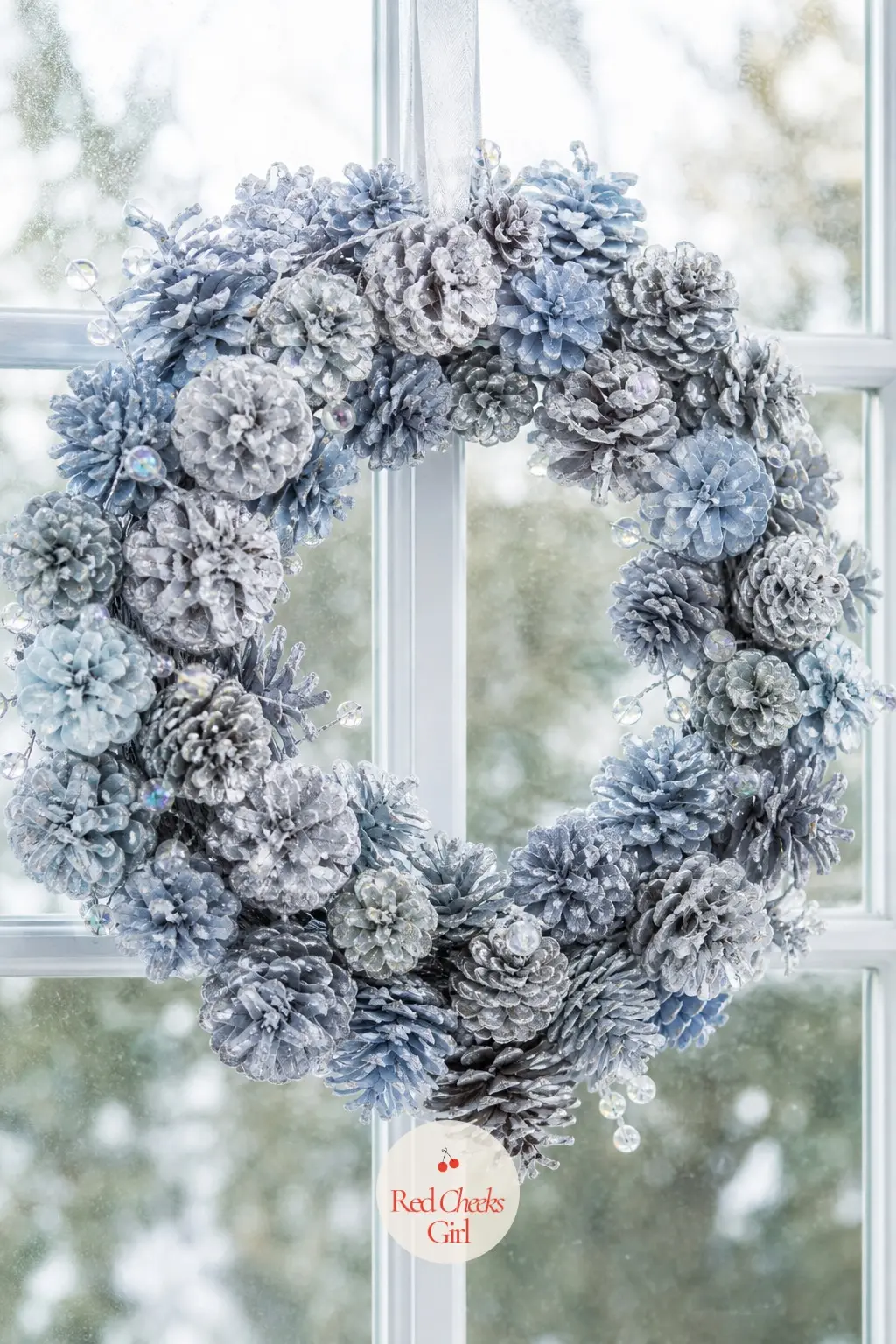 An Icy Pinecone Wreath for the Sunroom Window — A light silver dusting over a pale blue base coat gives the cones an iced look rather than a snowed one, cooler