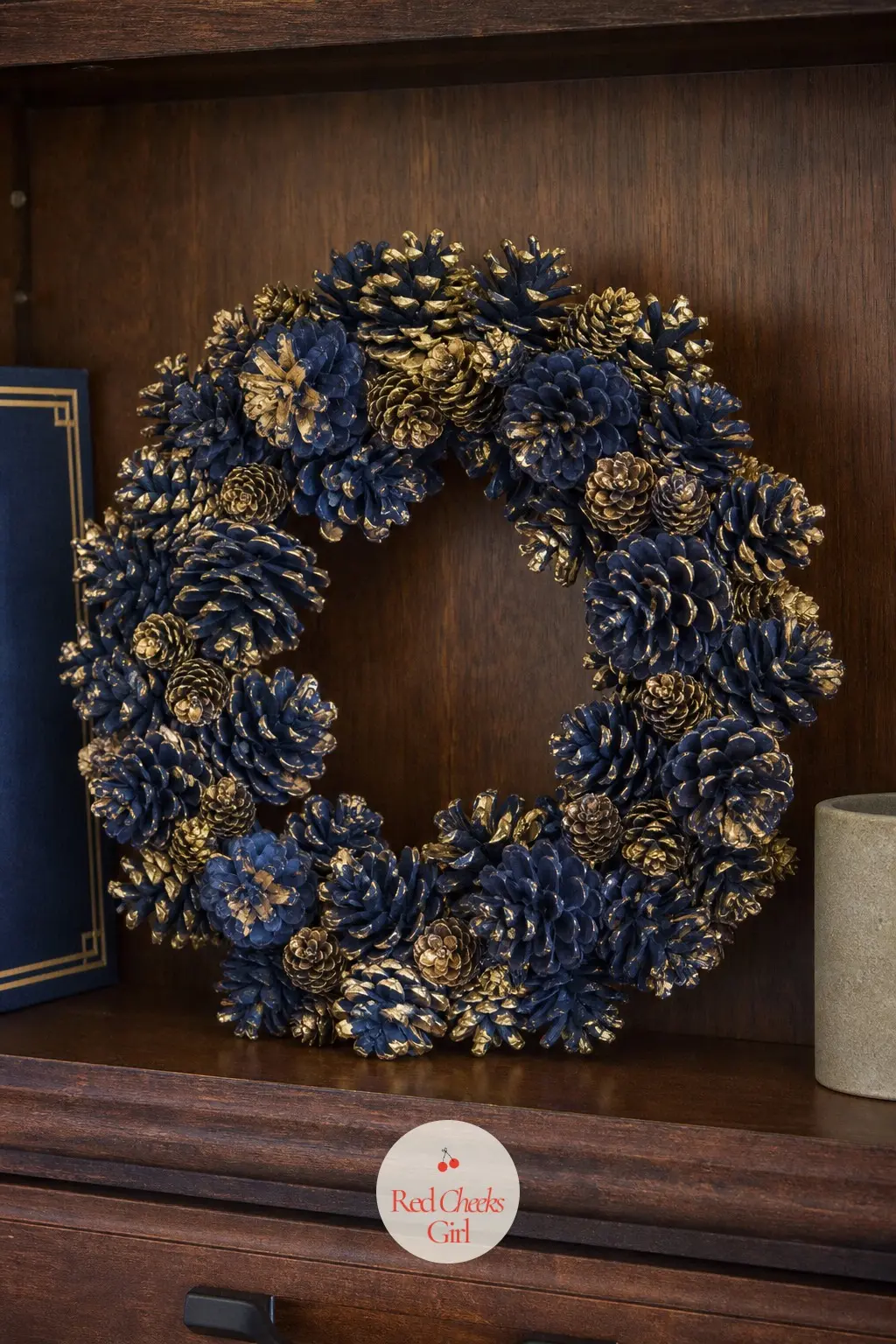 A Navy and Gold-Dusted Pinecone Wreath for the Home Office Shelf — Deep navy spray paint on the tips, then a light brush of gold mica powder while the paint is