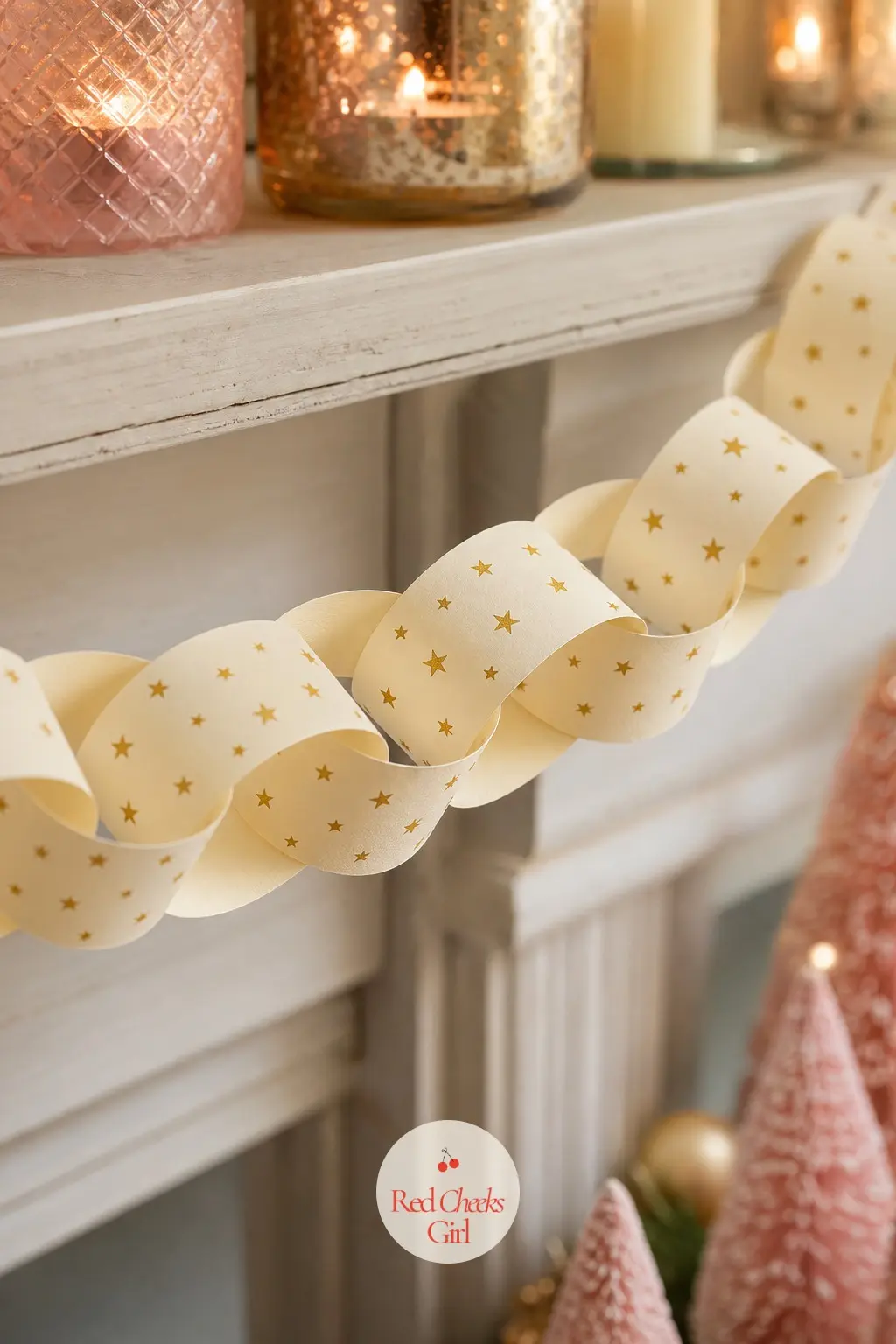 Gold Stars — A paper chain where each strip carries a scatter of small five-point stars in gold across a cream ground, like confetti caught mid-fall. Pink