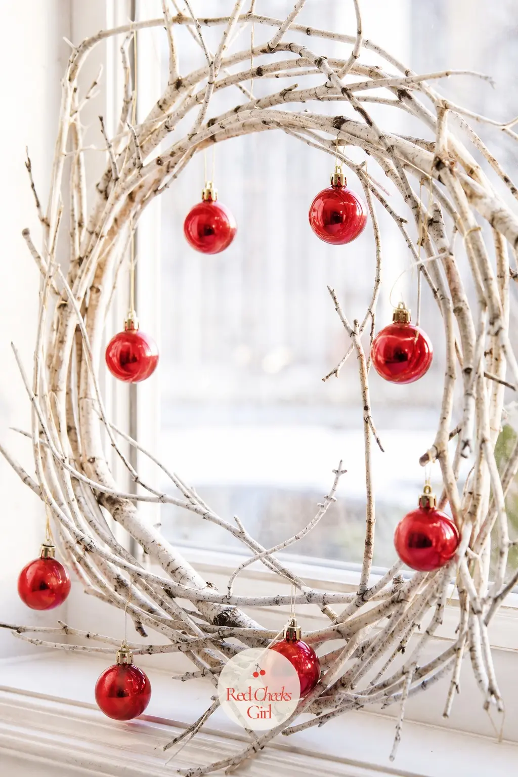 The Cherry Glass Ball and White Birch Branch Wreath for the Breakfast Nook Window — Bright cherry red glass balls in a single size hang against bare white
