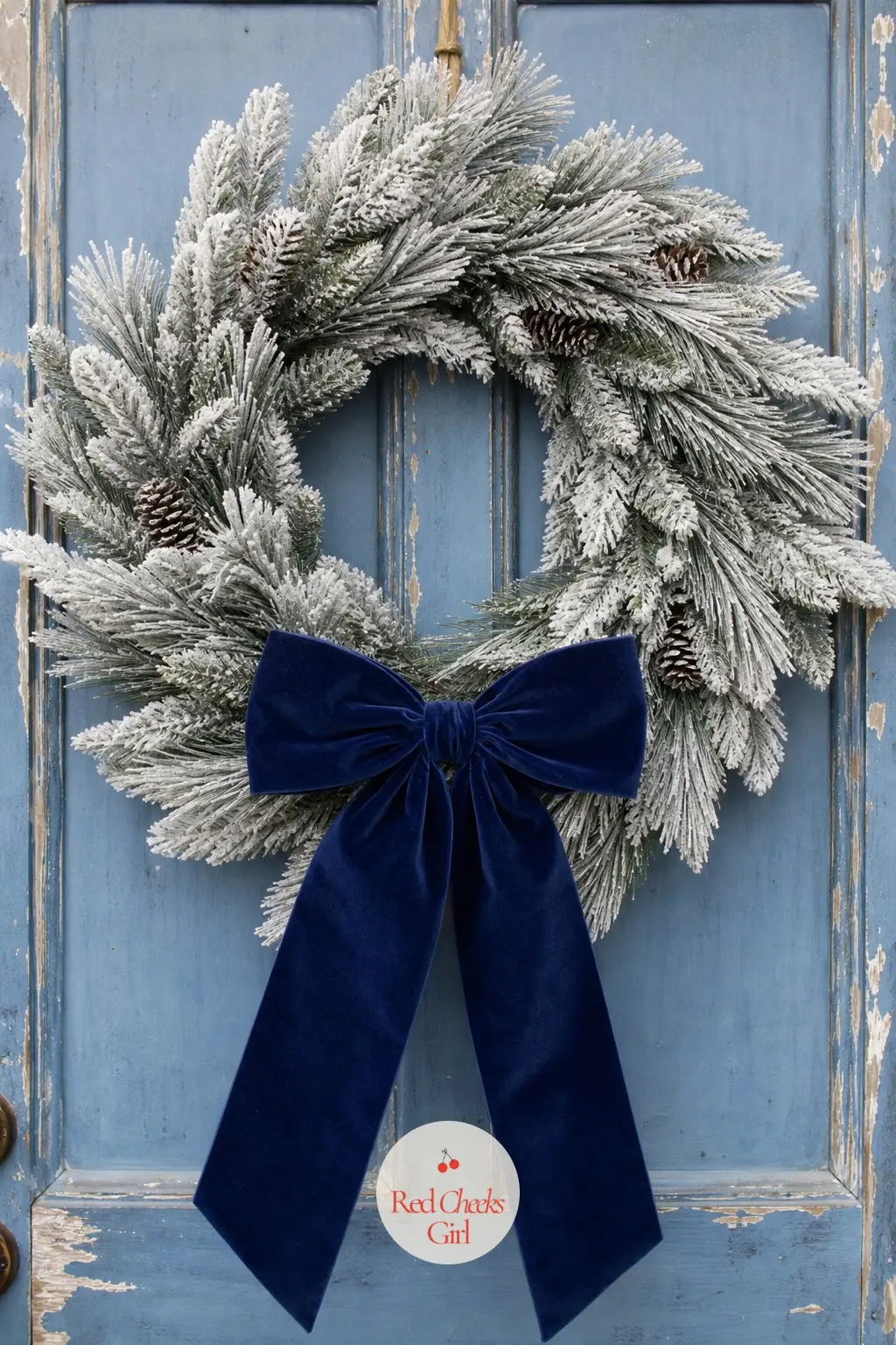 The Navy Velvet Ribbon and White Pine Wreath for the Coastal Cottage Door — A pale white-tipped pine wreath carries a single wide navy velvet bow at the