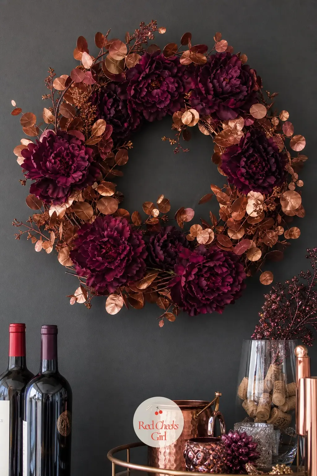 The Plum Silk Peony and Copper Eucalyptus Wreath for the Wine Bar Wall — Deep plum silk peonies sit open against eucalyptus stems sprayed a warm copper, the