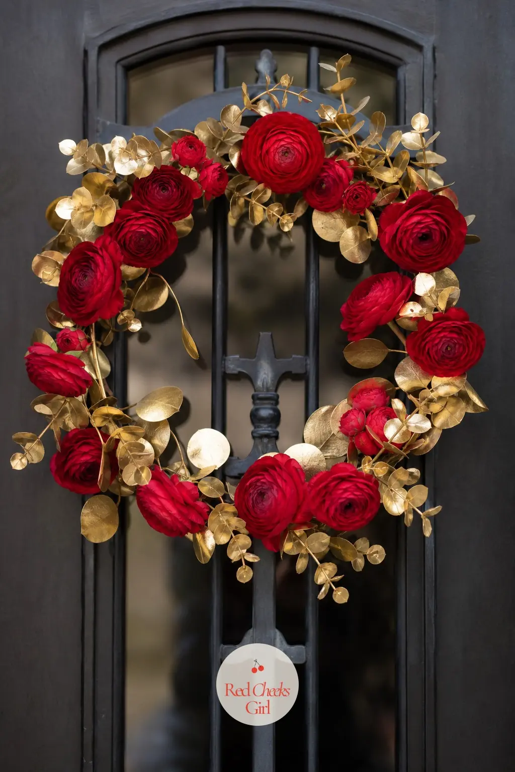 The Scarlet Ranunculus and Gold Eucalyptus Wreath for the Wine Cellar Door — Open scarlet ranunculus blooms sit among eucalyptus stems sprayed a soft metallic