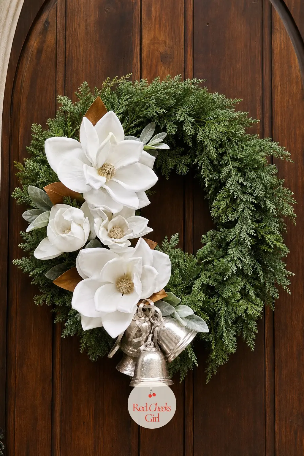The White Velvet Magnolia and Silver Bell Wreath for the Chapel Door — Oversized white velvet magnolia blooms sit at the base of the ring with small silver