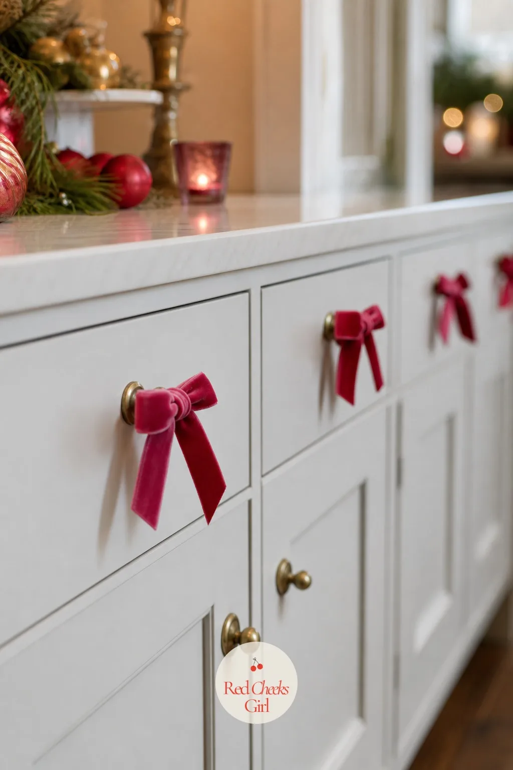 Mini Bows on Every Cabinet Knob — The kitchen cabinets are the last corner this theme reaches, and the smallest gesture it needs. Pink red and green christmas